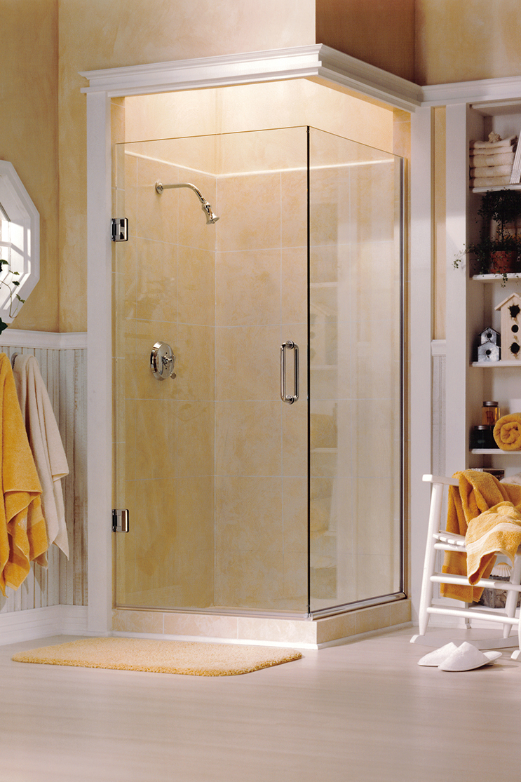 Brightly lit bathroom with heavy shower doors